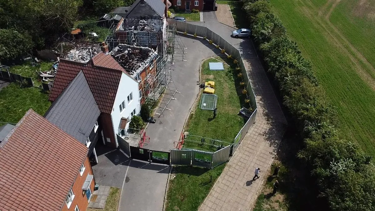Aerial view: NPS site fencing and scaffolding around fire-damaged property reinstatement