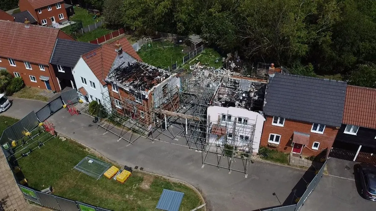 Drone view: full scaffolding access and shrink-wrap protection on fire-damaged terrace