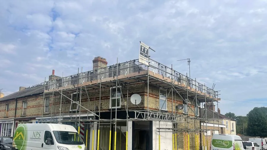 NPS major works site — operatives at scaffolded refurbishment project